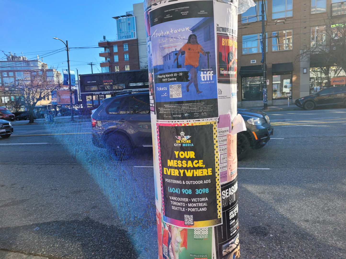 Skyline City Media Poster installed on a city cylinder in a parking lot in Vancouver