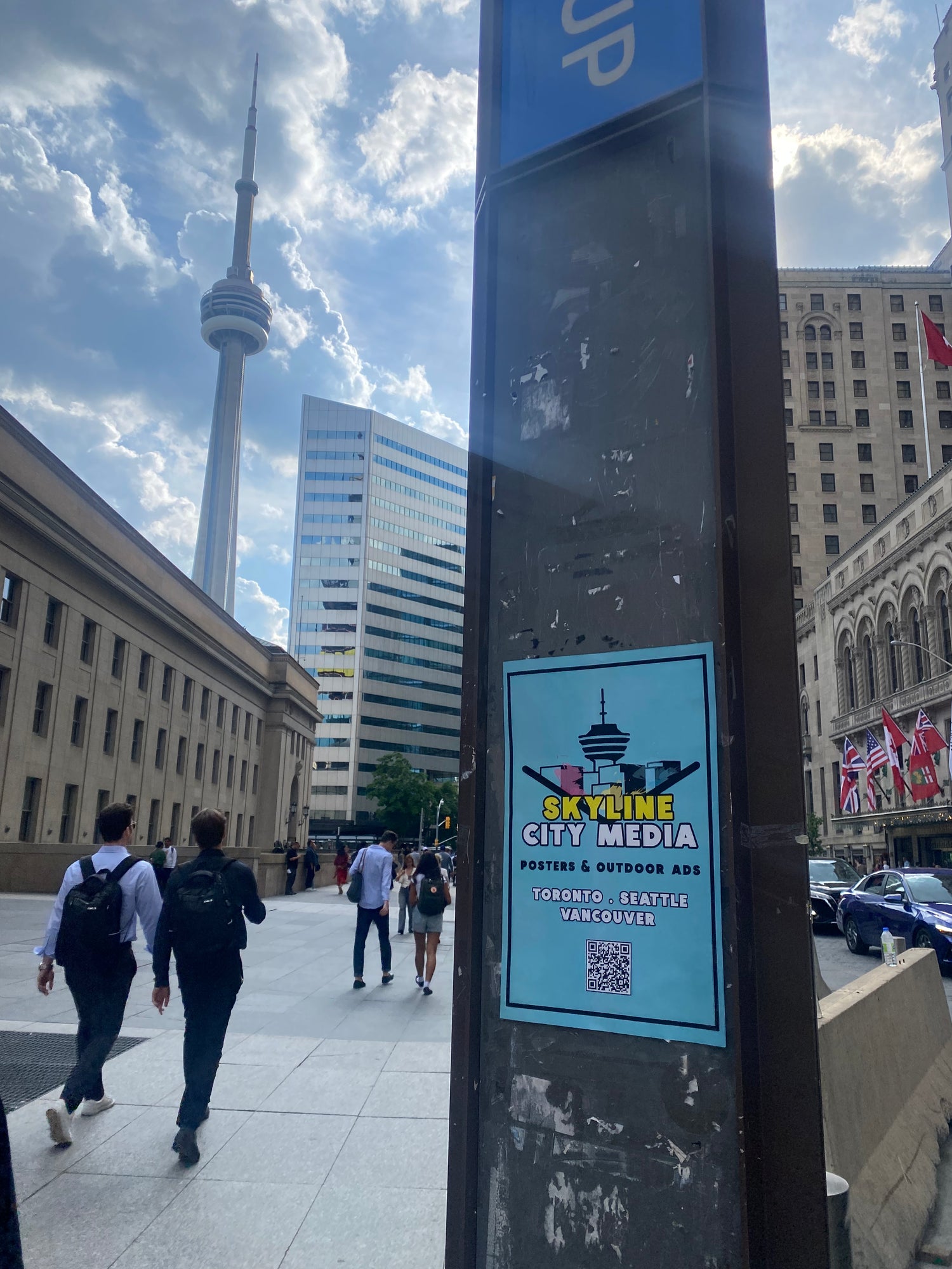 Skyline City Media postering Toronto's Union Station with a view of the busy street and the CN tower in the background