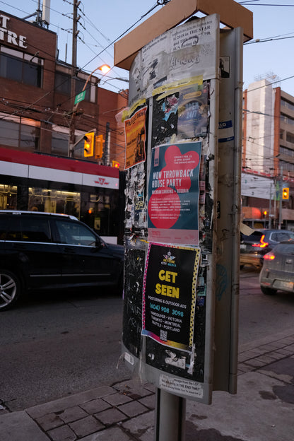 Postering campaigns in Downtown Toronto - a postering pole full of posters - distributed by Skyline City Media