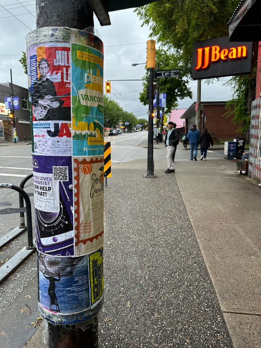 Posters on a telephone pole on Commercial Drive in Vancouver from Skyline City Media's Vancouver postering campaigns