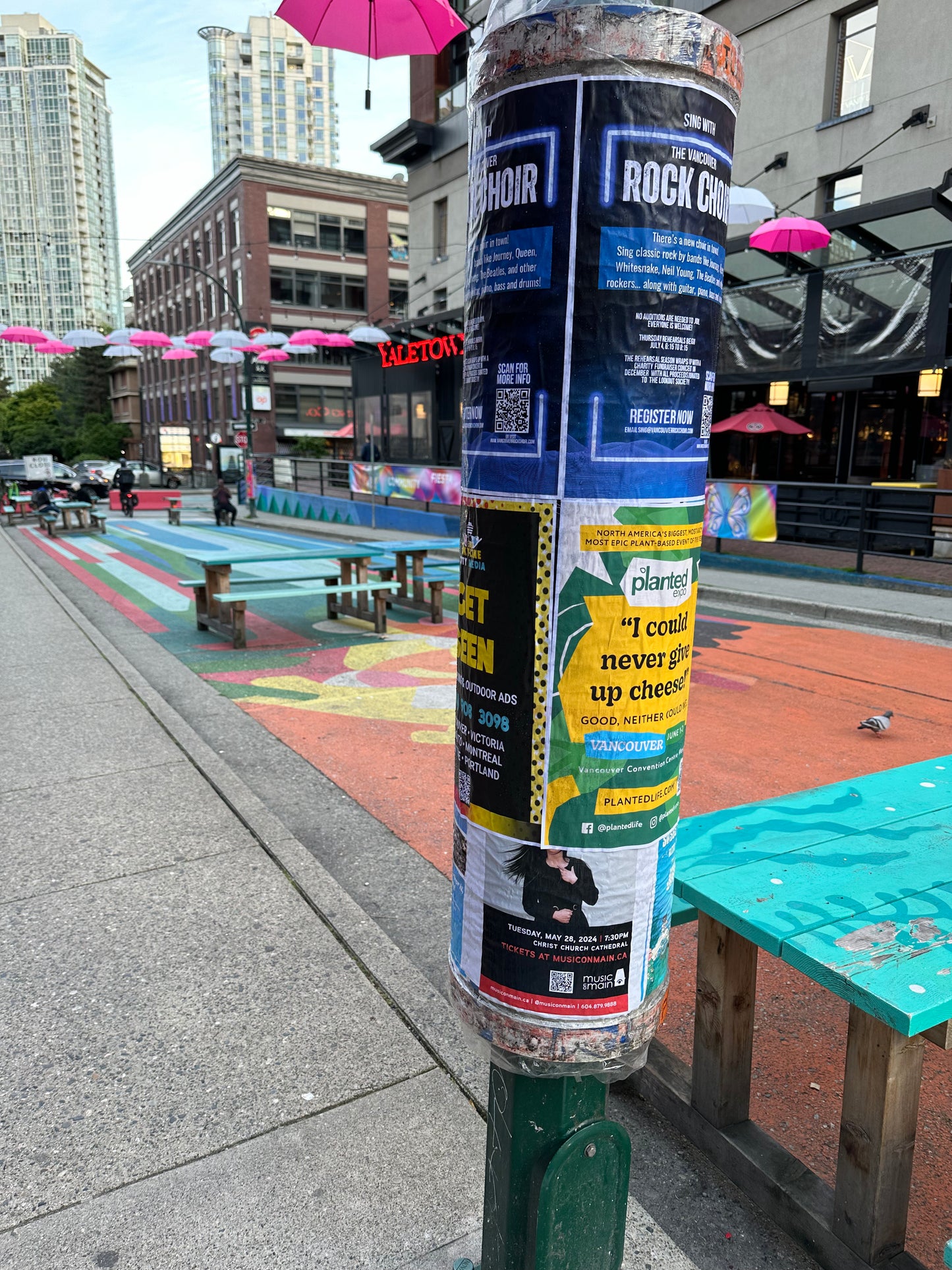 Postering in Vancouver, posters installed on a city cylinder on a colourful Yaletown block by Skyline City Media