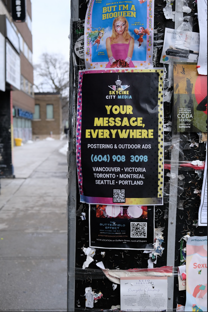 Skyline City Media's poster installed on a pole in downtown Toronto